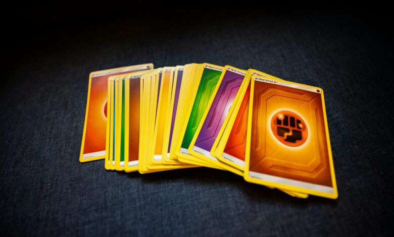From above of colorful pack of trading cards for game placed on gray surface