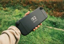 Person holding a Nintendo Switch in a natural outdoor setting, perfect for on-the-go gaming.