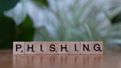 Wooden tiles spelling 'phishing' highlight cybersecurity themes.