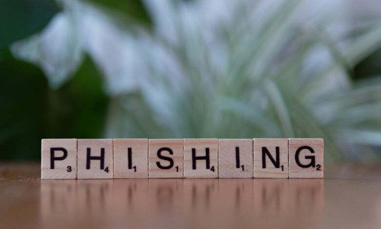 Wooden tiles spelling 'phishing' highlight cybersecurity themes.
