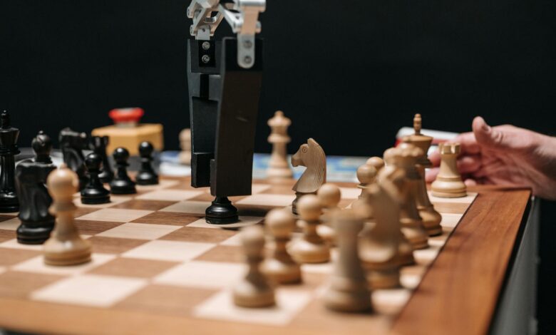 Close-up of a robotic arm playing chess against a human, showcasing AI technology in a classic board game setting.