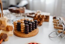 Close-up of various wooden brain teaser puzzles arranged on a table indoors.