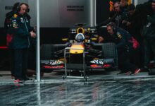 Red Bull Racing pit crew readying the Formula 1 car during an intense race event.