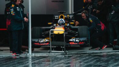 Red Bull Racing pit crew readying the Formula 1 car during an intense race event.