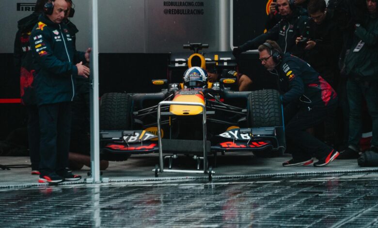 Red Bull Racing pit crew readying the Formula 1 car during an intense race event.