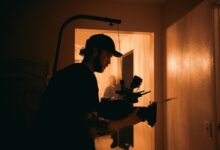 Cinematographer using advanced camera rig indoors with warm lighting.