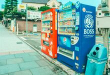 Colorful vending machines offering snacks and drinks on a street in Kobe, Japan.