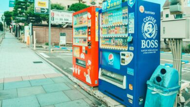 Colorful vending machines offering snacks and drinks on a street in Kobe, Japan.