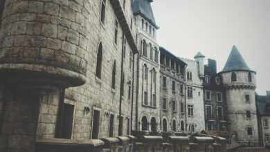 A medieval stone castle exterior with turrets and windows, creating a historic and mysterious atmosphere.