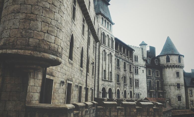 A medieval stone castle exterior with turrets and windows, creating a historic and mysterious atmosphere.