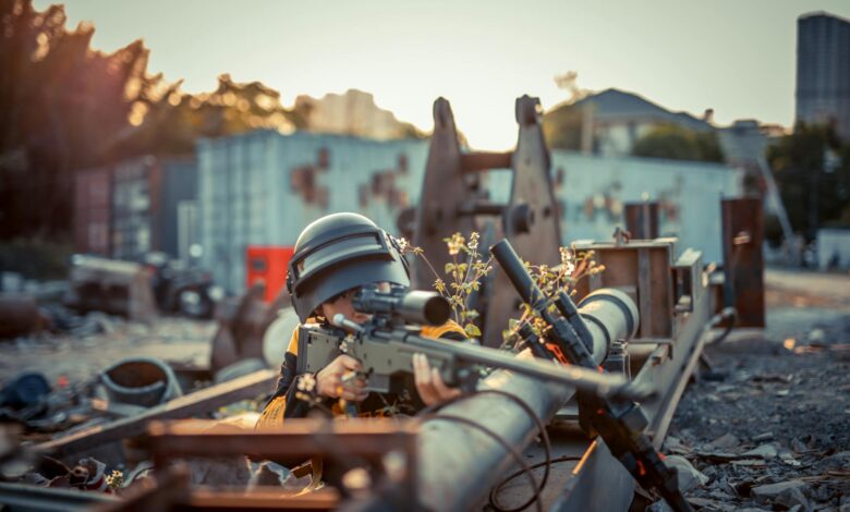 Person with helmet aiming toy gun in urban setting. Conceptual scene with dramatic effect.