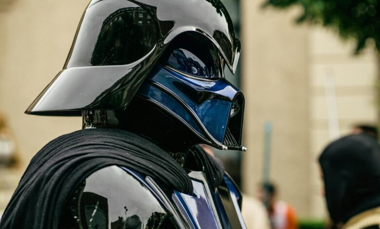Detailed side view of a cosplayer dressed as Darth Vader at an event.