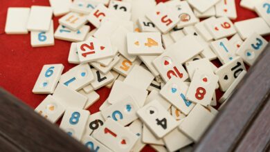 A collection of numbered game tiles scattered on a red surface, perfect for game night themes.