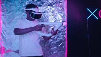 Man playing an immersive virtual reality game with VR goggles and controller.