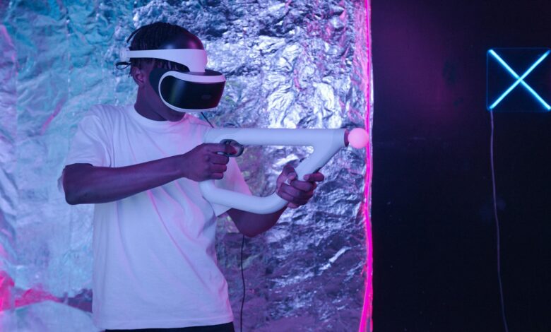 Man playing an immersive virtual reality game with VR goggles and controller.