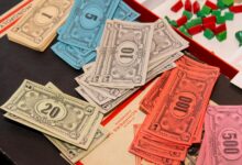 Colorful Monopoly money and game pieces arranged on a game board for a classic board game night.
