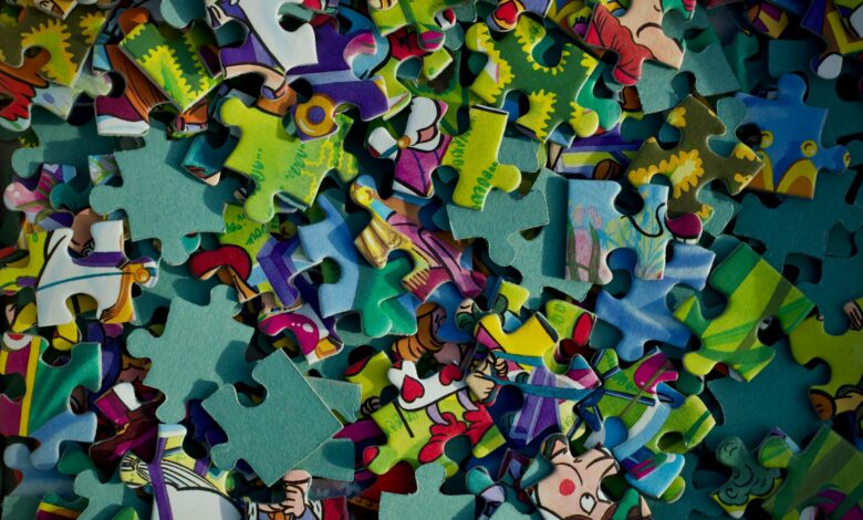 Vivid close-up of colorful jigsaw puzzle pieces scattered randomly.