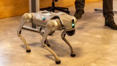 A robotic dog stands indoors, showcasing advanced technology with a sleek design.