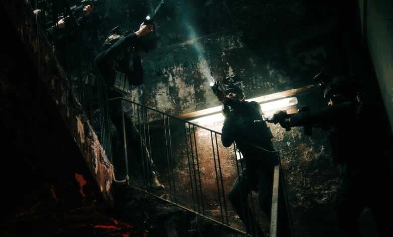 Special forces team conducting a tactical operation in a dimly lit, abandoned building.