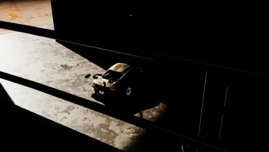 Luxury sports car in shadows of a modern garage space.