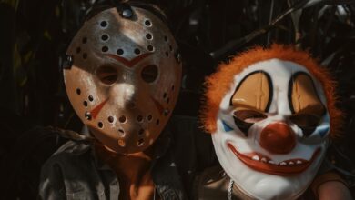 Children wearing horror masks in a dimly lit cornfield, capturing Halloween spirit.