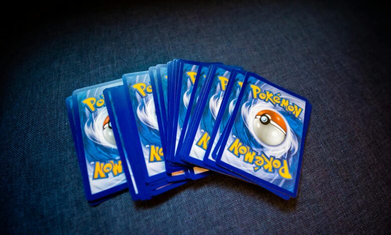 High angle of set of trading cards with images of fictional creatures placed against gray background