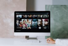 A modern workspace featuring a desktop screen displaying popular streaming series on Netflix.