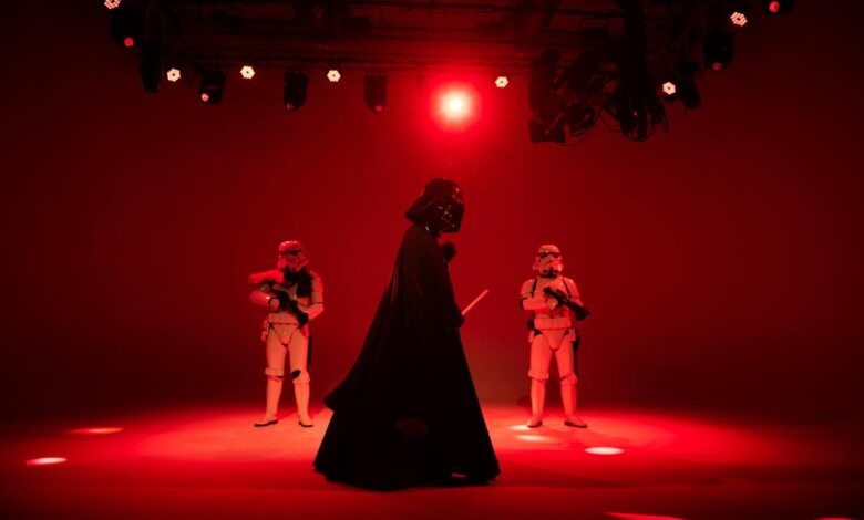 Star Wars characters in dramatic red lighting on a stage. Perfect for entertainment-themed imagery.