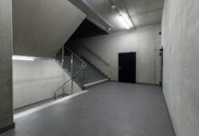 A modern and minimalist concrete stairwell showcasing industrial architecture.