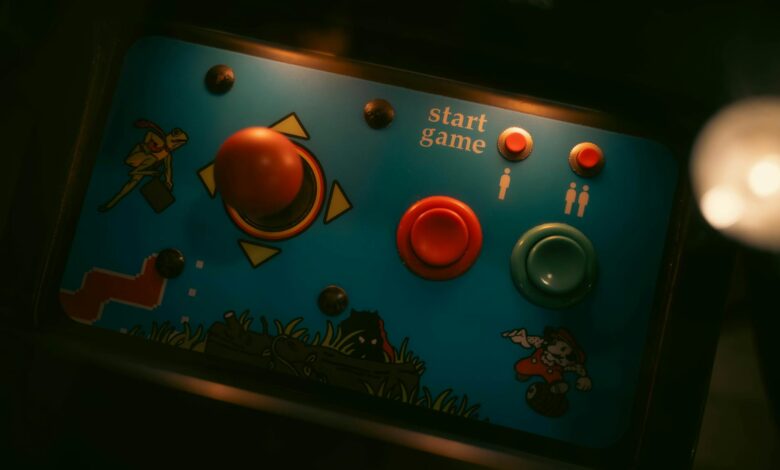 Close-up of retro arcade game controls with joystick and buttons