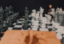 Detailed close-up of a medieval themed chess set highlighting strategy and artistry in black and white.
