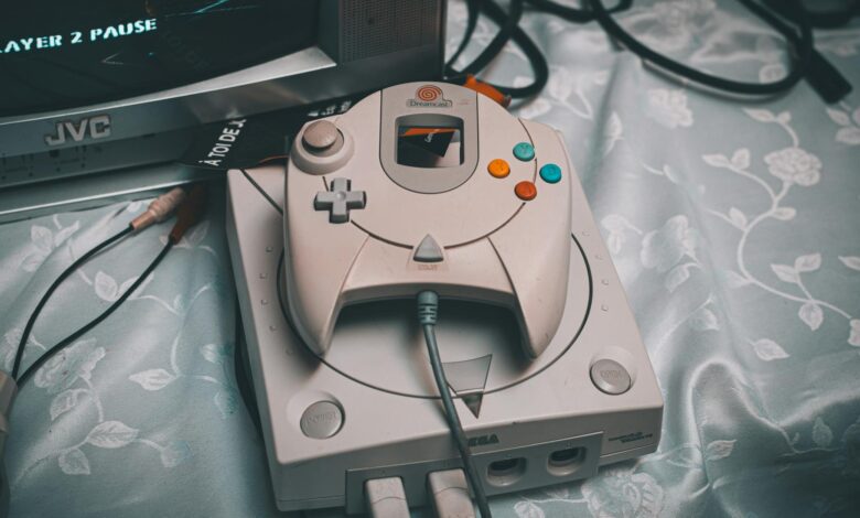 Close-up of a Sega Dreamcast console with controller and CRT monitor in a retro gaming setup.