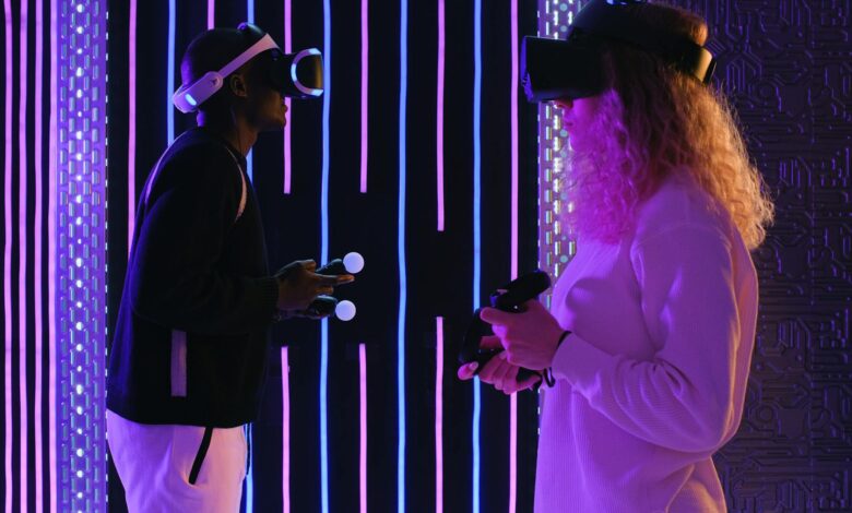 Two adults enjoying virtual reality gaming in a vivid neon-lit room for an immersive experience.