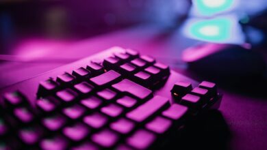 A close-up view of an RGB backlit gaming keyboard with a vibrant purple glow, perfect for tech and gaming enthusiasts.