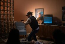 Teens creatively engage in play, pretending to be in a suspenseful movie scene indoors.