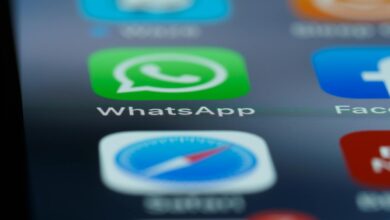 Detailed close-up of a smartphone's home screen displaying popular applications like WhatsApp.