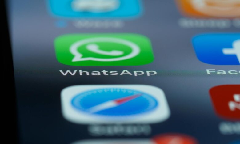 Detailed close-up of a smartphone's home screen displaying popular applications like WhatsApp.
