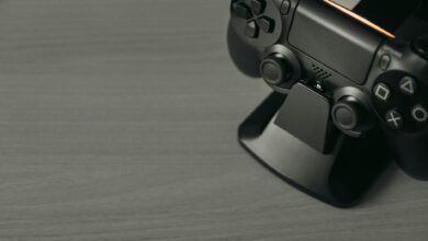 Black PS4 controller on display stand with copy space