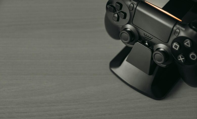 Black PS4 controller on display stand with copy space