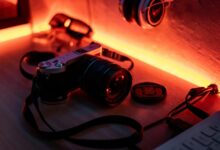 Retro camera on a desk with warm ambient lighting, evoking a nostalgic vibe.