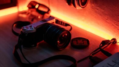 Retro camera on a desk with warm ambient lighting, evoking a nostalgic vibe.