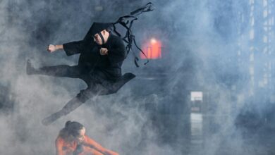 Two cosplayers enact a thrilling martial arts battle immersed in foggy atmosphere.