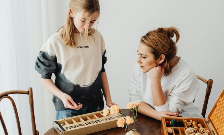 A mother and daughter engaged in puzzle-solving, enhancing creativity and bonding indoors.