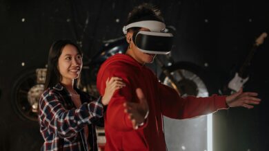 Young couple engaging in VR gaming indoors, wearing a virtual reality headset.