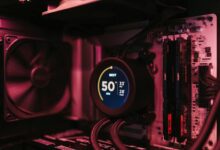 Close-up of a PC cooling system and motherboard, highlighting digital temperature display.