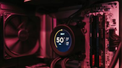 Close-up of a PC cooling system and motherboard, highlighting digital temperature display.