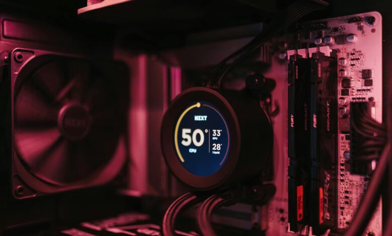 Close-up of a PC cooling system and motherboard, highlighting digital temperature display.