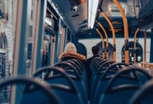 Passengers traveling on a city bus through London, capturing urban commuting life.