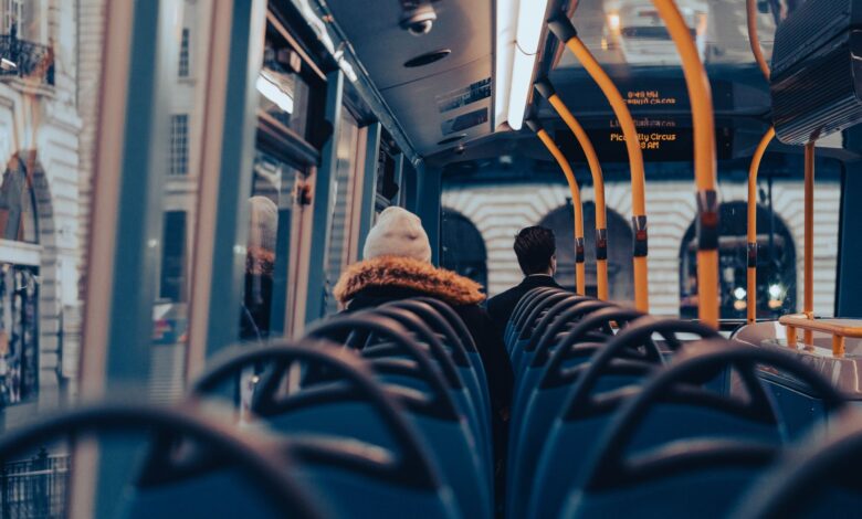 Passengers traveling on a city bus through London, capturing urban commuting life.
