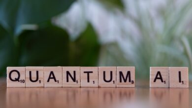 Wooden letter tiles spelling 'Quantum AI' on a blurred background.